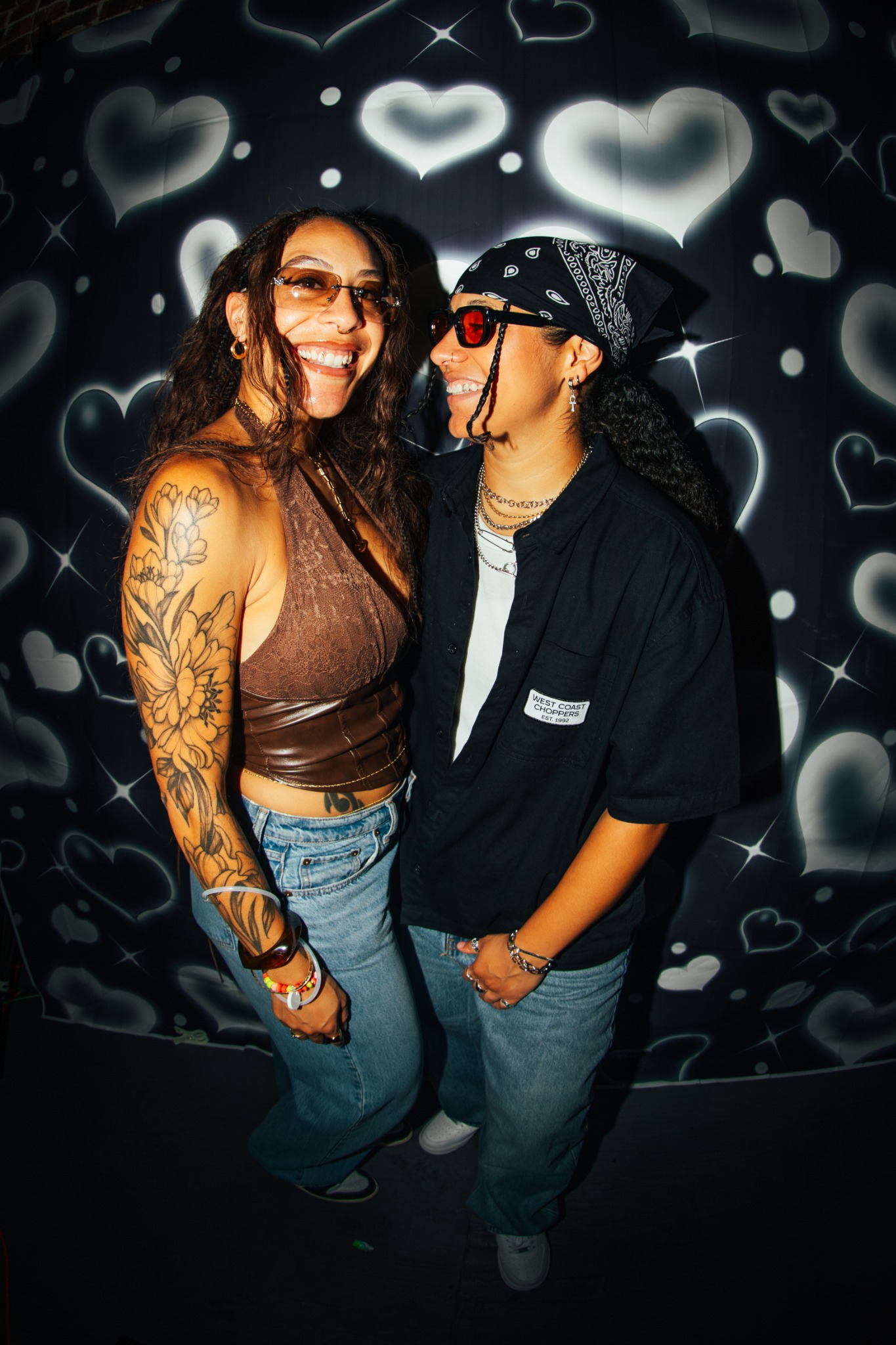 TOMBOY guests in front of heart backdrop